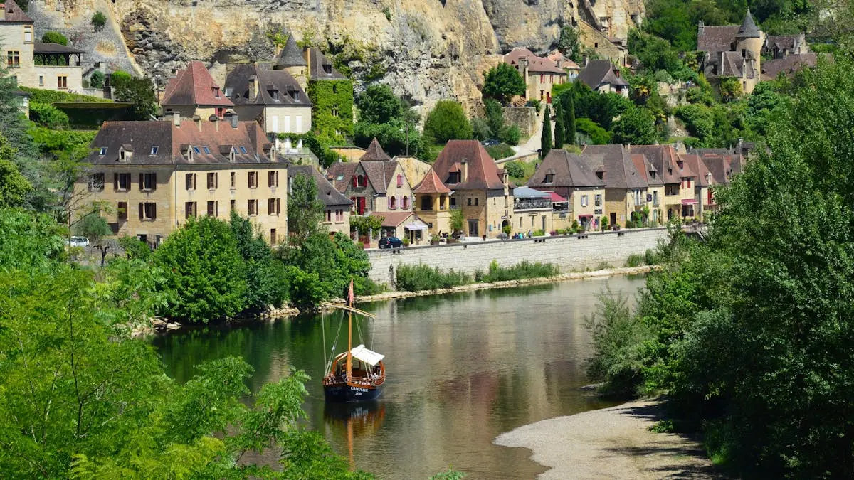 Picturesque village by the river with charming architecture and lush greenery.
