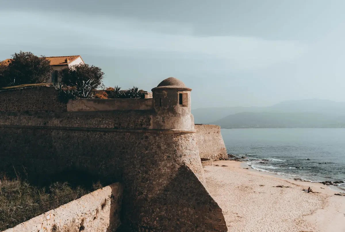 Explore the historic citadel on Corsica's coastline with its sandy shore and impressive fortifications.