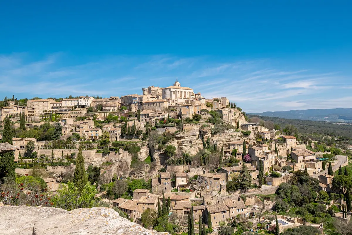 Breathtaking view of the picturesque village of Gordes in Provence, France under a clear blue sky.