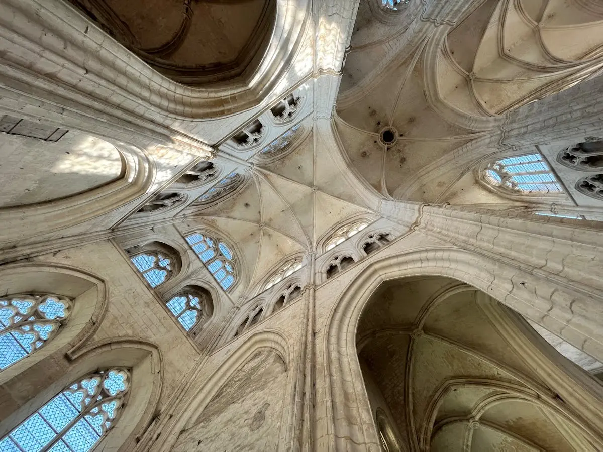 Intricate gothic architecture of a vaulted ceiling in Auxerre Cathedral, France.