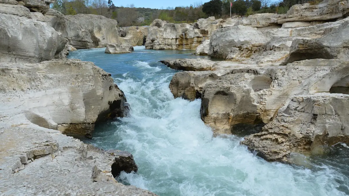 Rushing water through the rocky landscapes of La Roque-sur-Cèze, France.