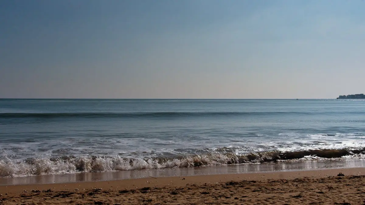 Tranquil beach scene at La Baule with gentle waves and a clear blue sky.