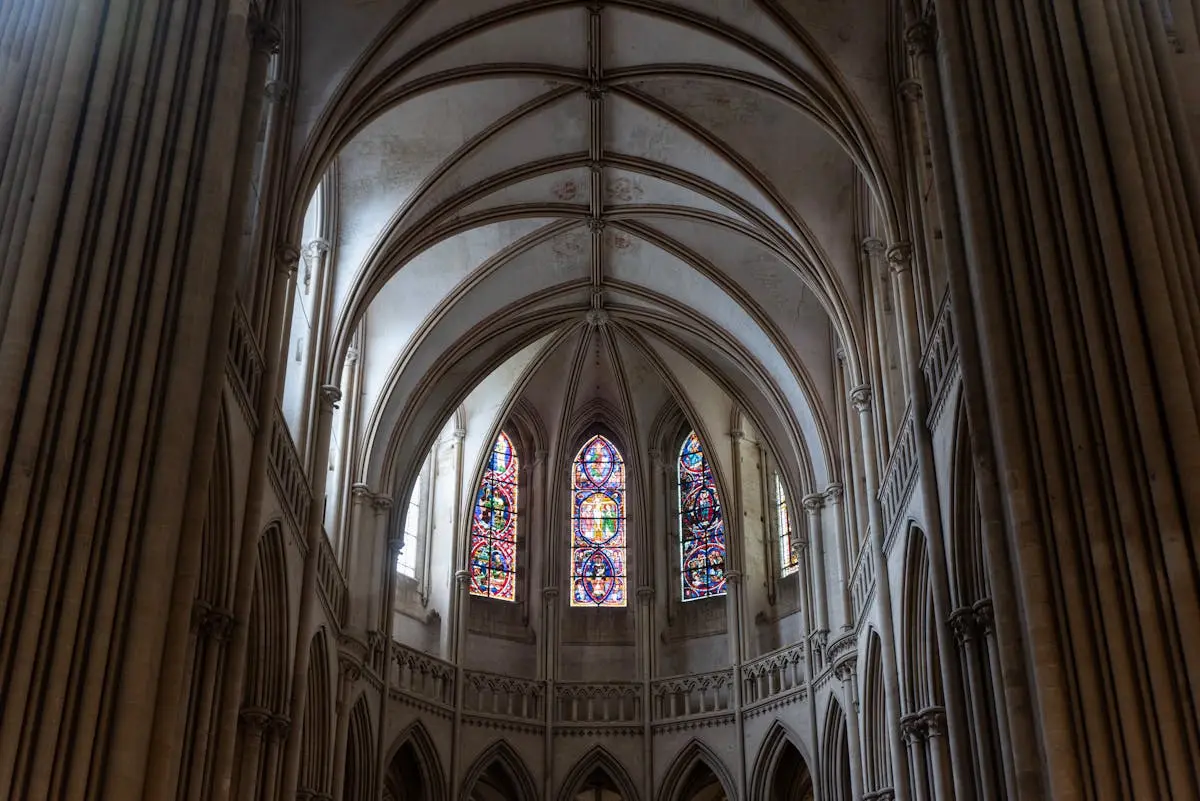 Gothic cathedral interior showcasing stunning stained glass windows and arches.