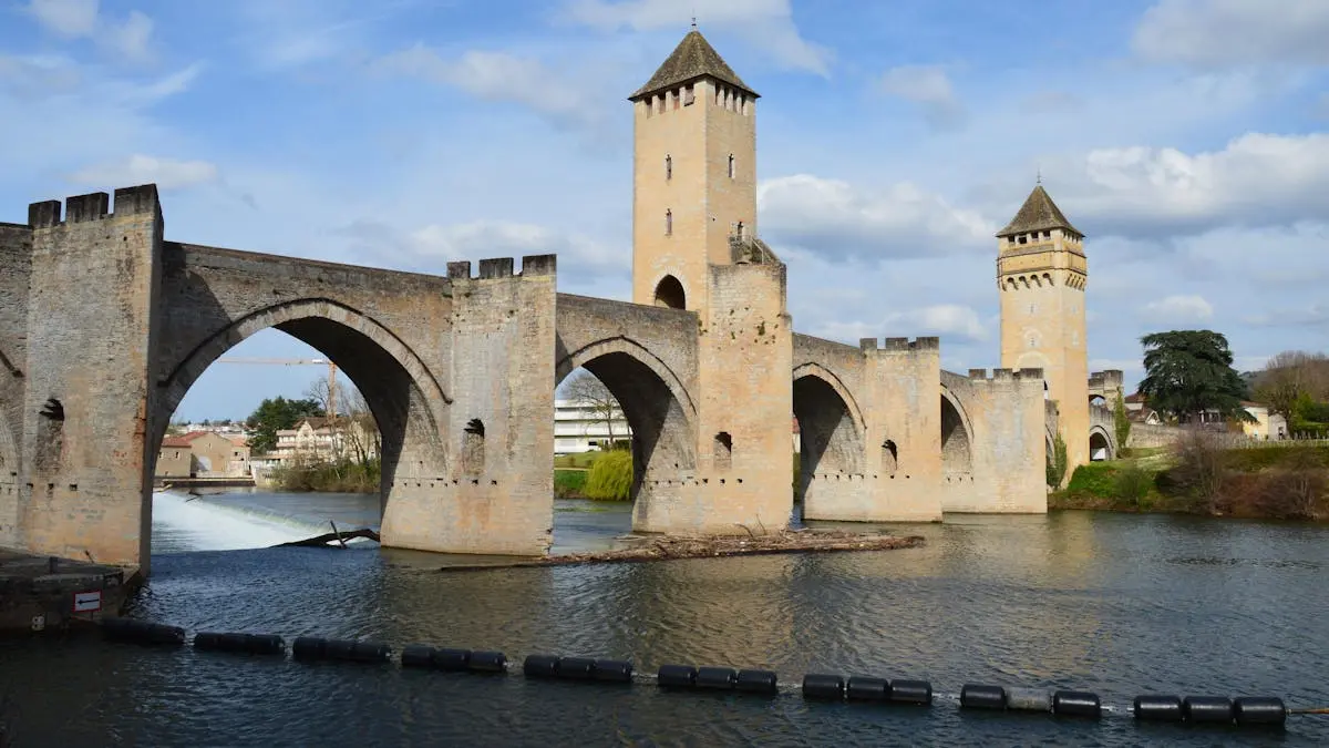 Explore Pont Valentré, a stunning medieval bridge in Cahors, with its iconic towers and river view.