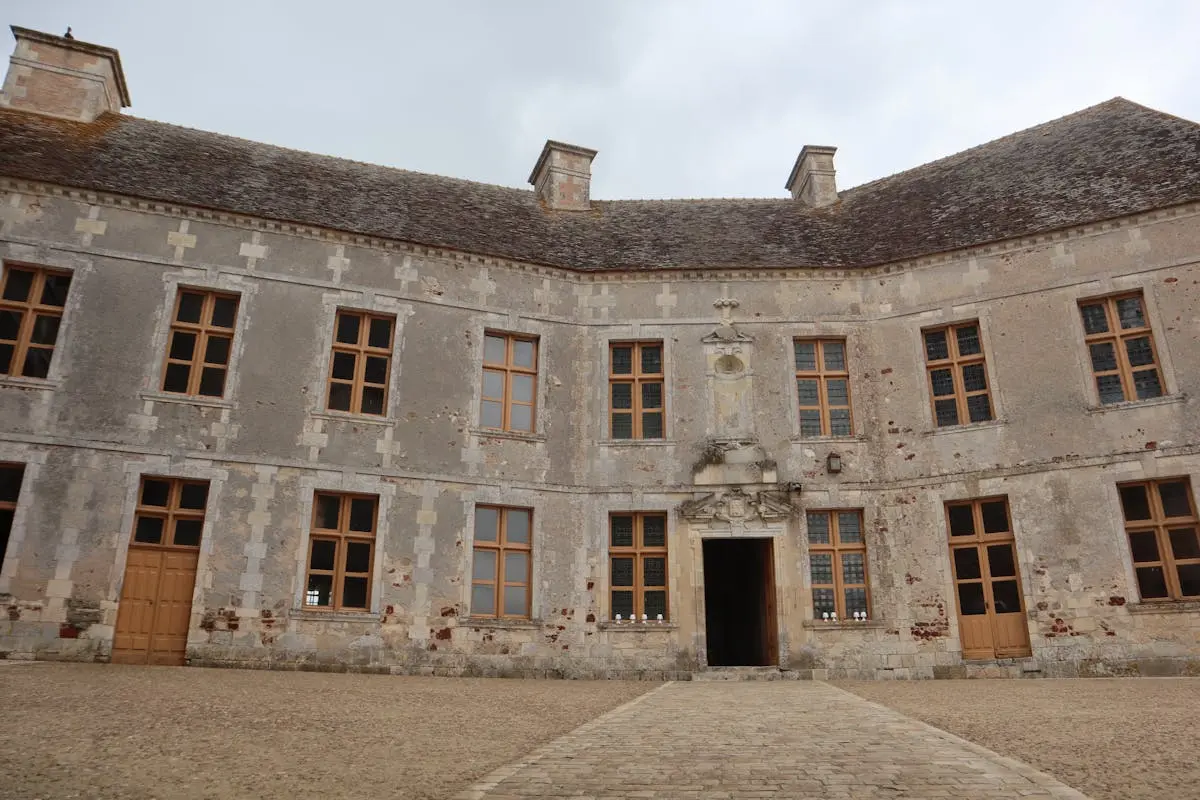 Stone facade of a historic chateau in Rosnay, France, showcasing classic French architecture.