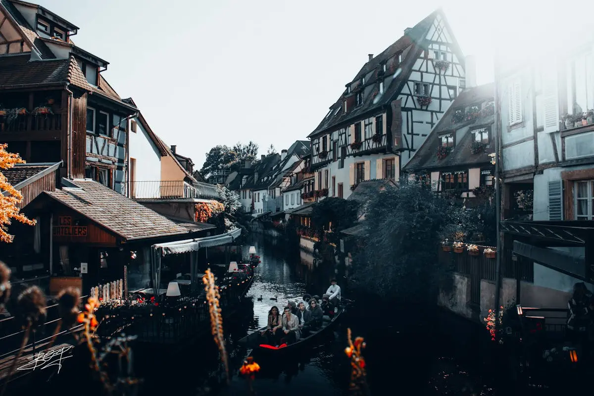 Idyllic view of Colmar's canals with half-timbered houses and a boat ride.