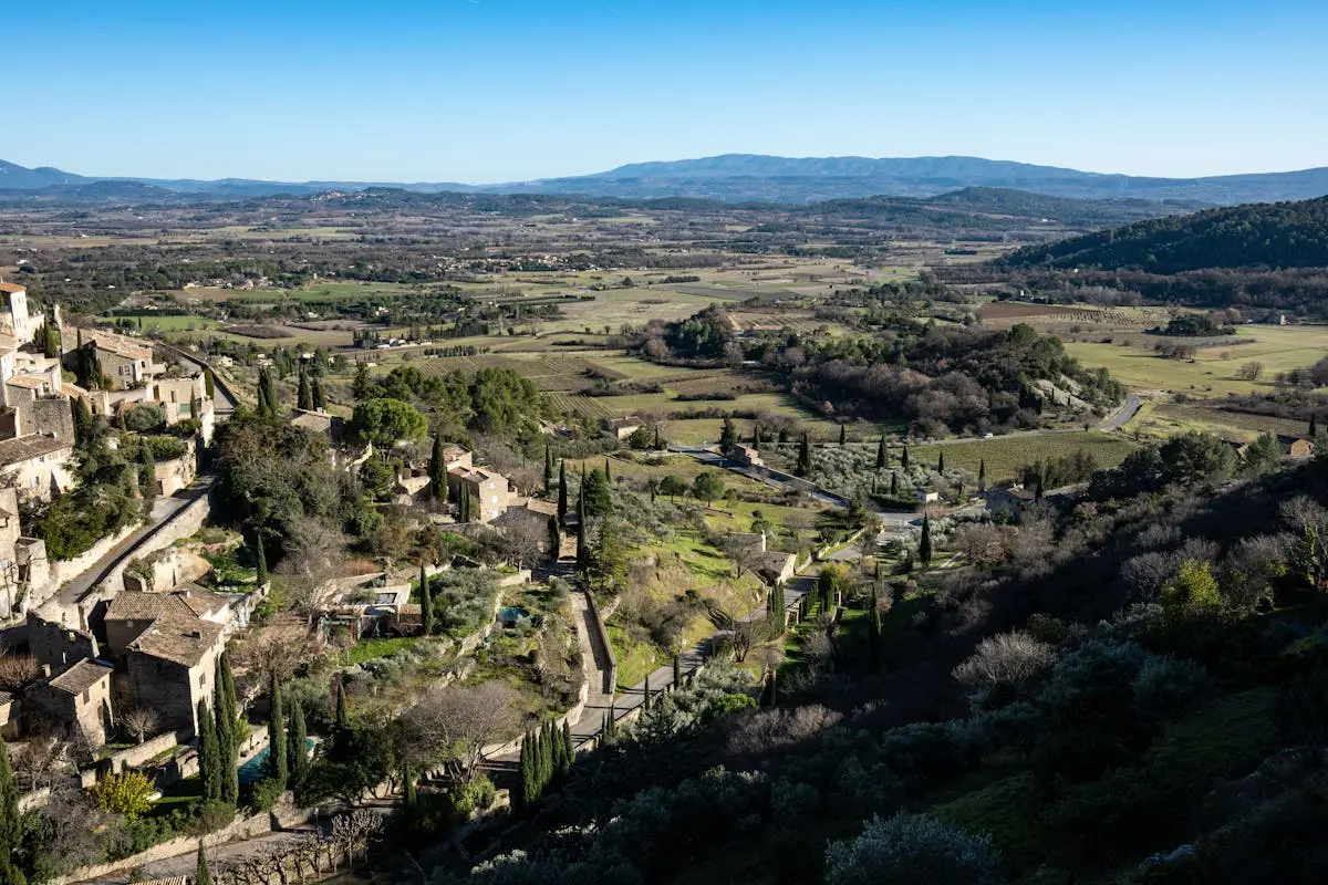 Aerial view of Gordes, a beautiful village in Provence, France with lush landscapes and historic architecture.