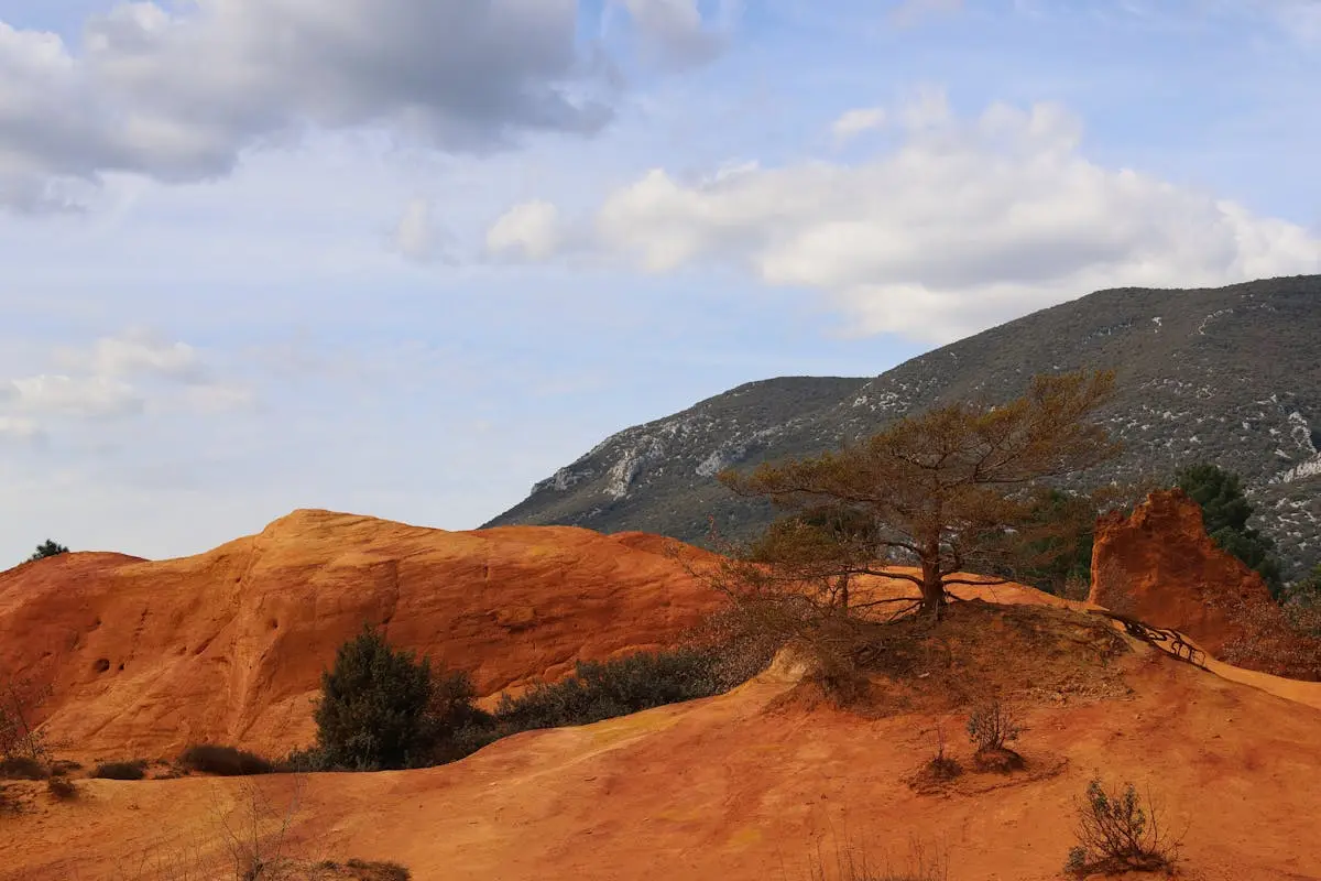 Scenic view of Colorado Provençal's orange cliffs and blue sky in Rustrel, France.