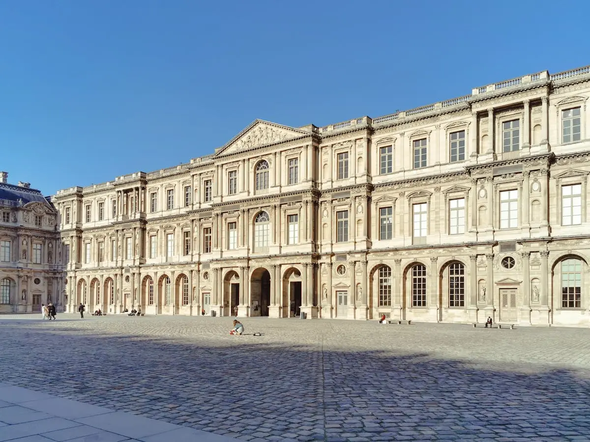 Stunning view of the Baroque architecture of the Louvre in Paris on a clear day.