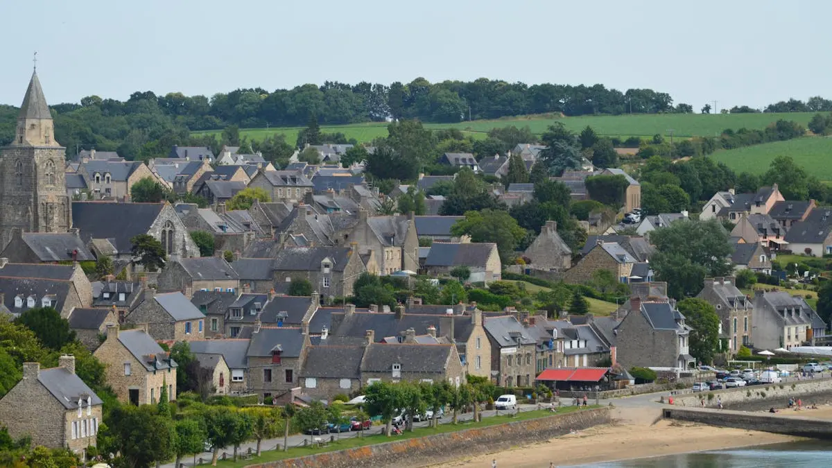 Picturesque view of Saint-Suliac village with historic architecture and lush greenery.