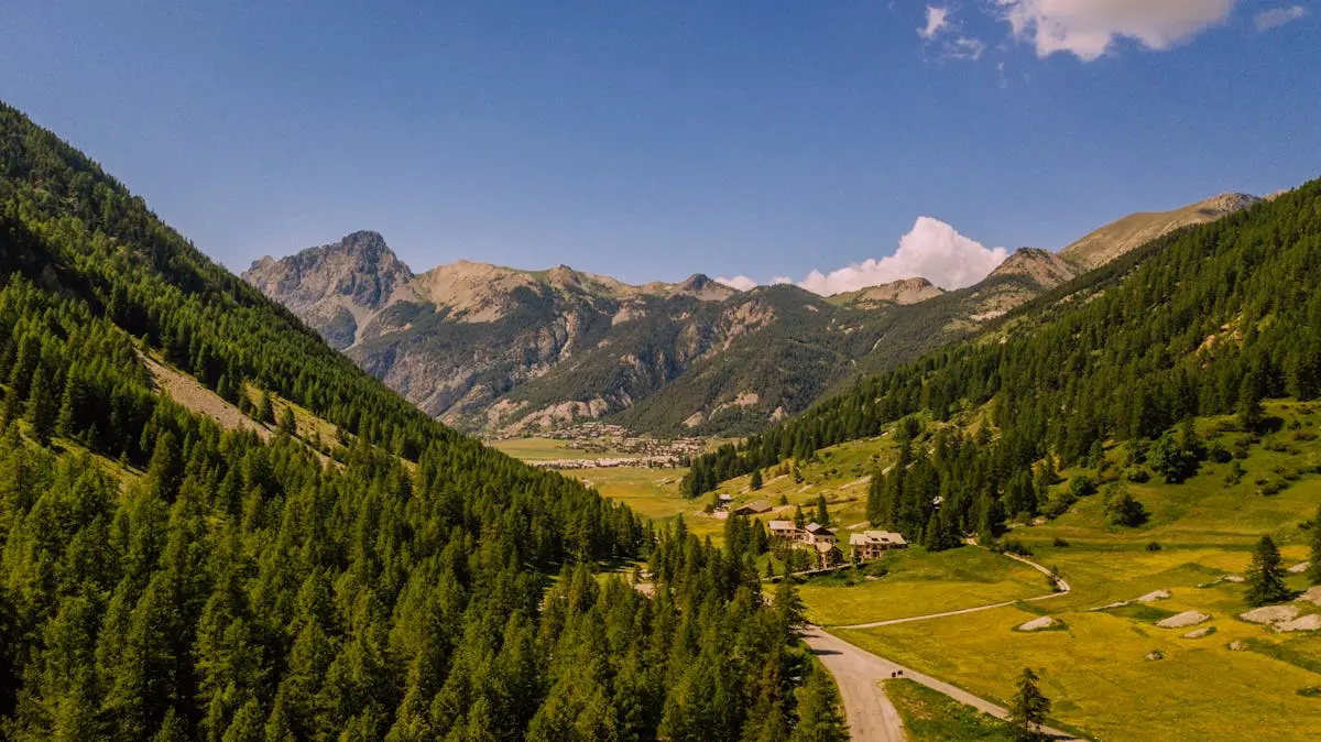 Breathtaking aerial view of a lush alpine valley in the French Alps during summer.