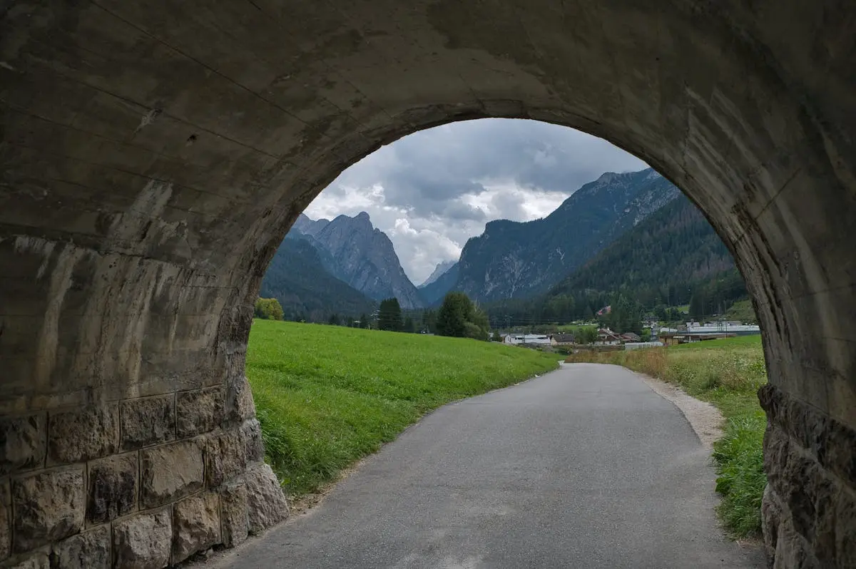 Picturesque landscape view through a tunnel opening in Toblach, Trentino-Südtirol, Italy.