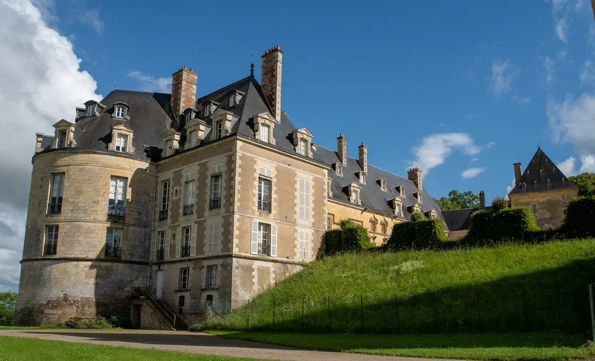 A majestic view of Château de Apremont under a bright blue sky in summer.