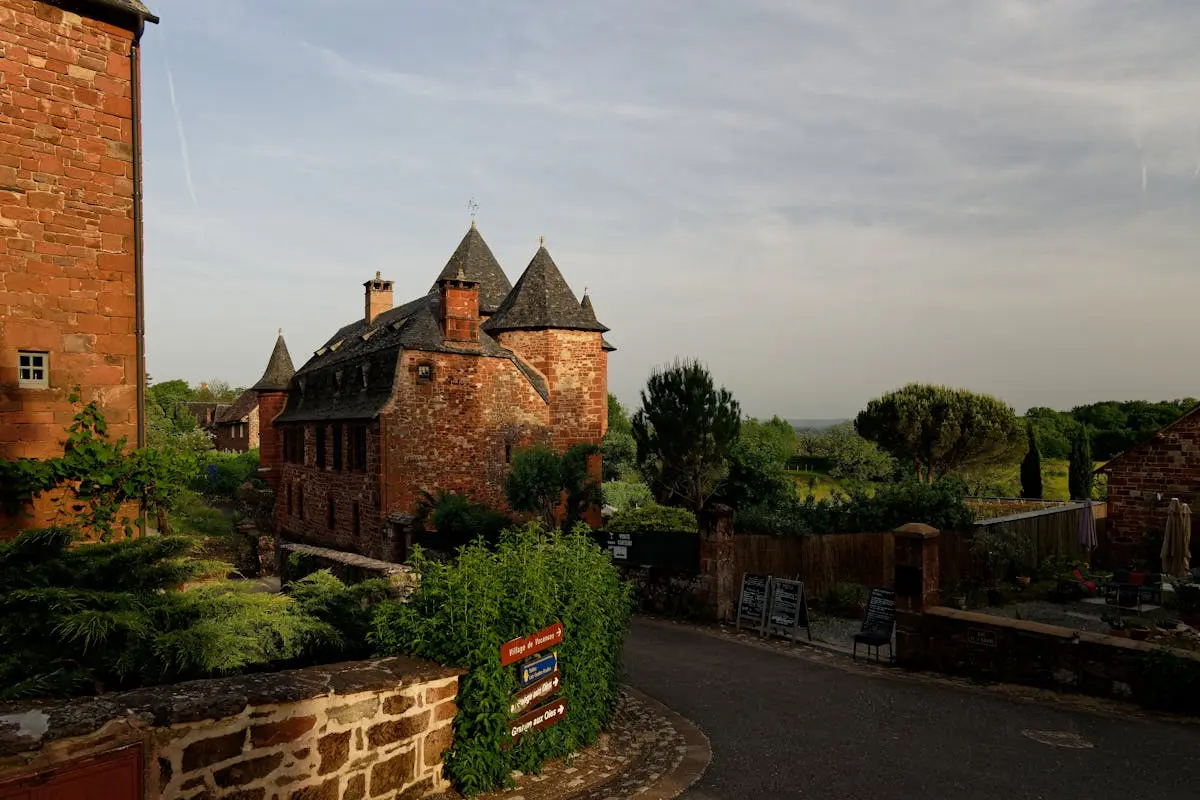 Explore the picturesque red-brick architecture of Collonges-la-Rouge, France, captured at sunset.