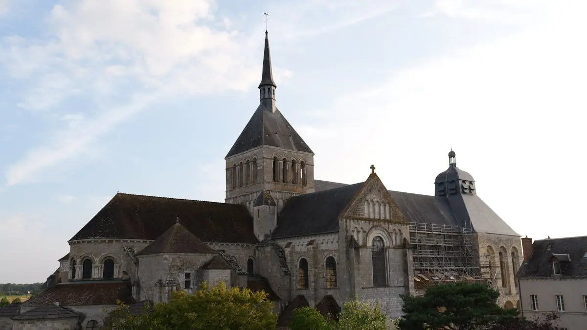 Stunning architectural view of the Abbey of Fleury, Saint-Benoît-sur-Loire, under a clear sky.