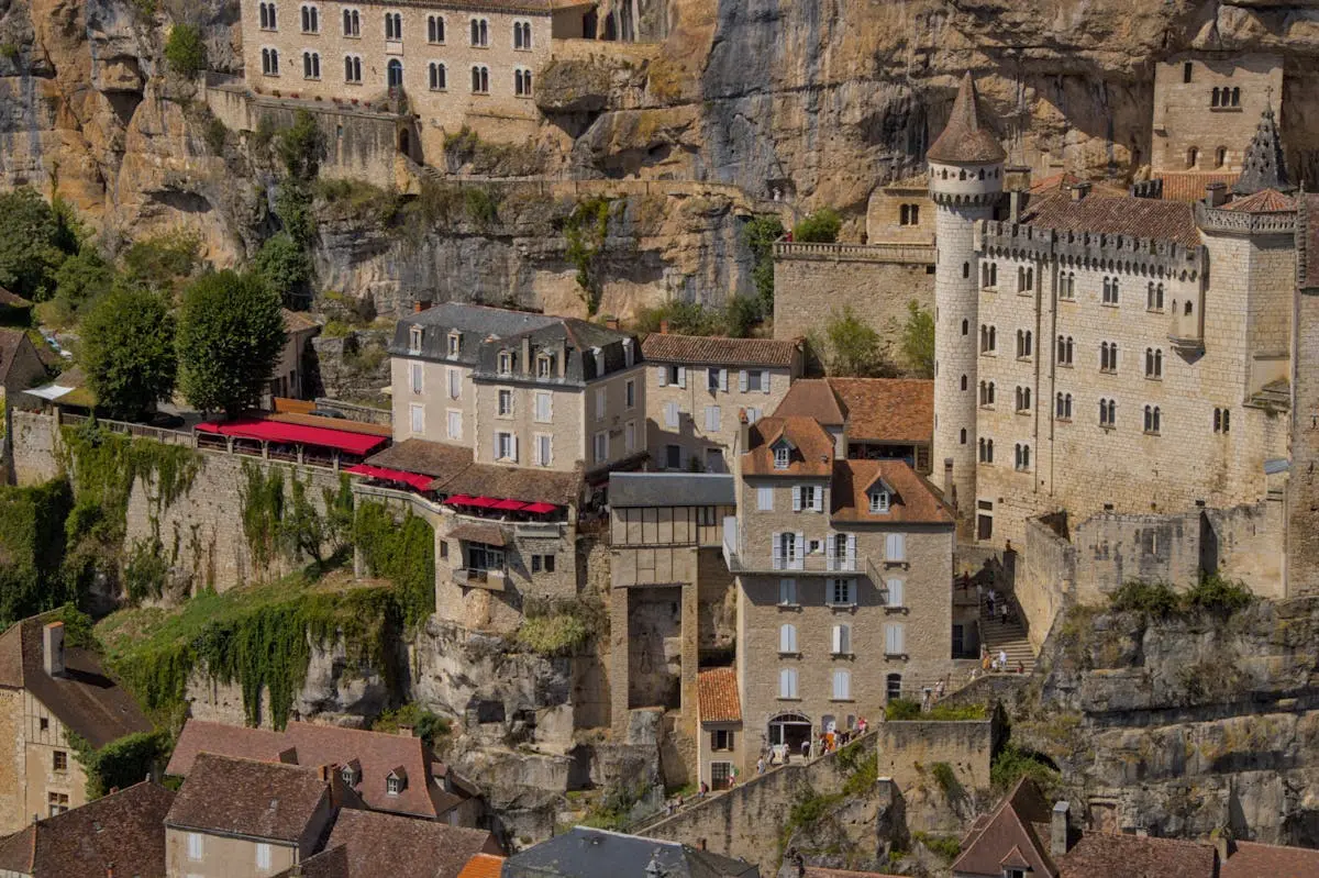 A stunning view of the historic cliffside village of Rocamadour with medieval architecture and limestone cliffs.