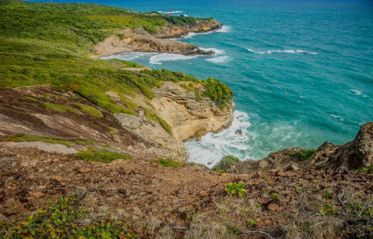 Breathtaking view of rugged coastal cliffs and turquoise ocean waves crashing ashore.