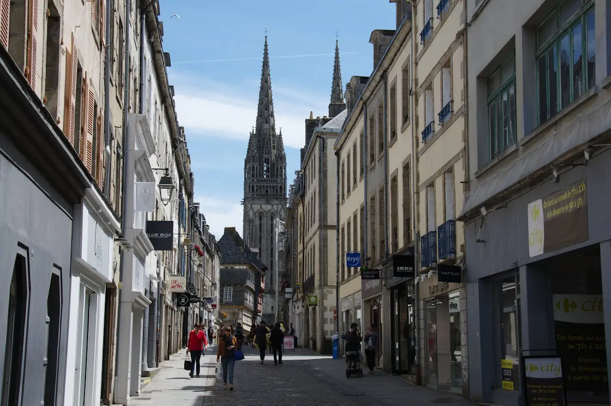 Explore the bustling streets of Quimper, France, showcasing gothic architecture and local life.