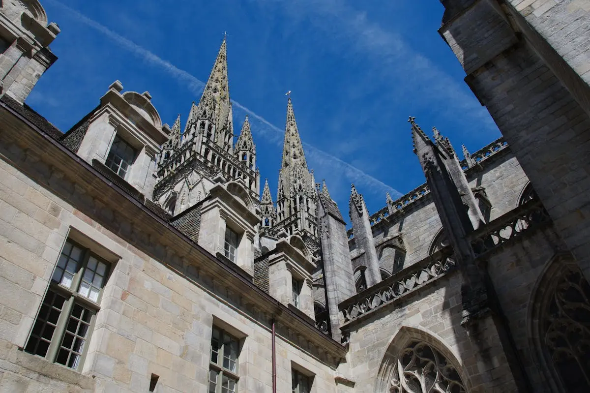 Low-angle view of the Gothic architecture of Saint Corentin Cathedral in Quimper, France.