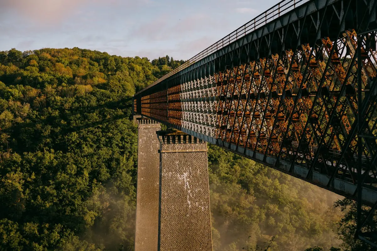 Stunning view of Viaduc des Fades over lush forests in autumn, capturing the serene beauty of Auvergne-Rhône-Alpes.