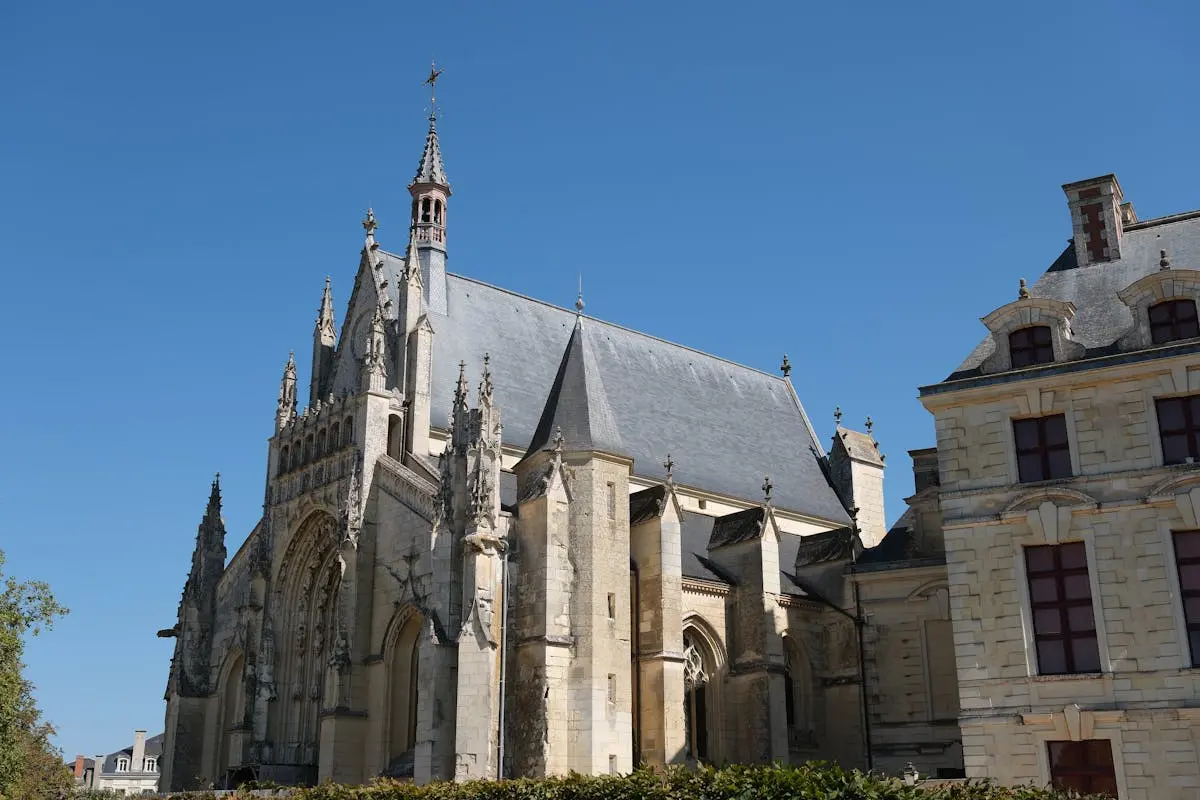 Magnificent view of a historical Gothic cathedral facade showcasing intricate architecture under a clear blue sky.