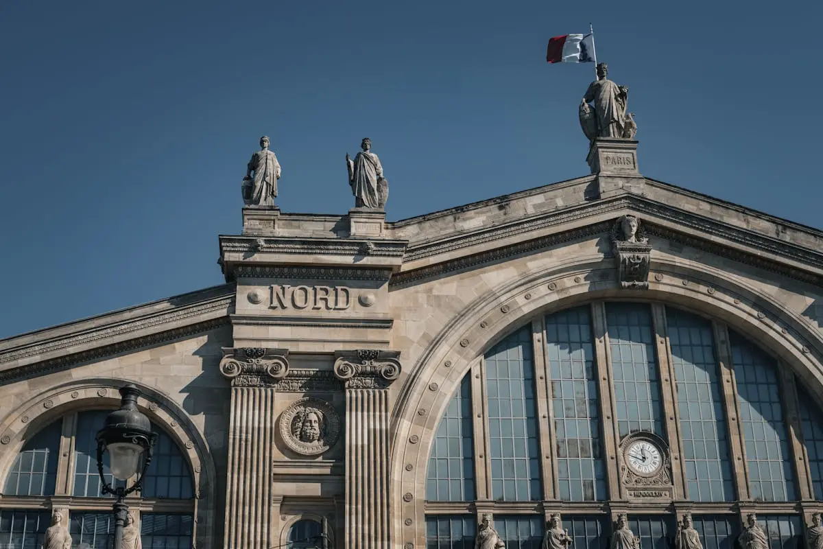 Capture of Gare du Nord showcasing elegant 19th-century architecture under clear skies in Paris.