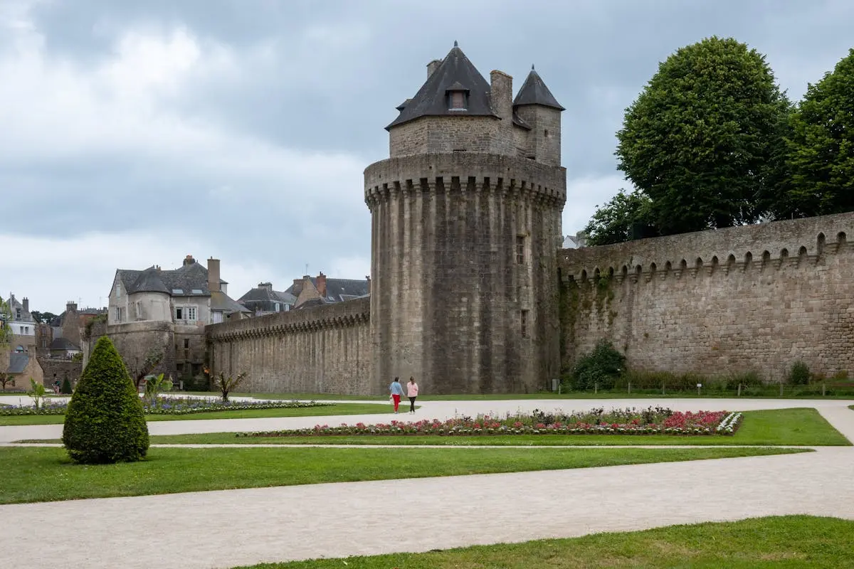 Explore the historic ramparts of Vannes, Brittany with lush gardens and medieval architecture.